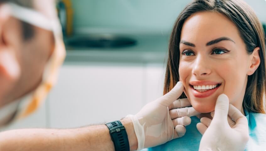 Cosmetic dentist in Yarmouth looking at a smiling patient