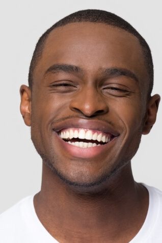 Man with straight white teeth grinning