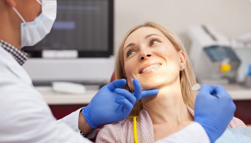 Woman smiling at her dentist during preventive dentistry checkup