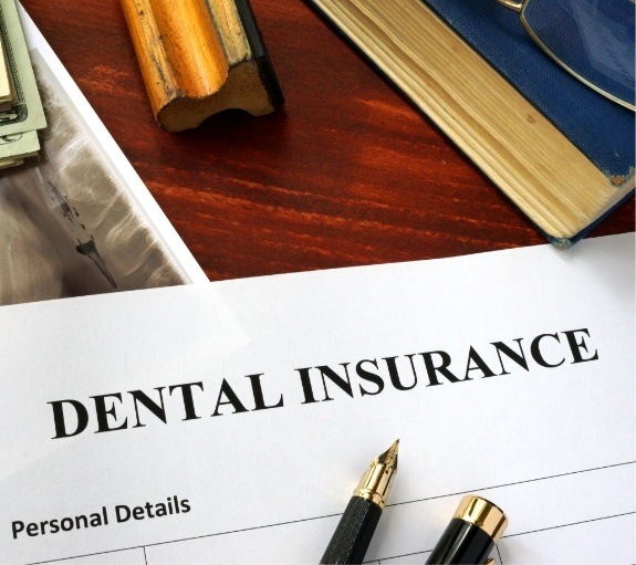 Dental insurance paperwork on table