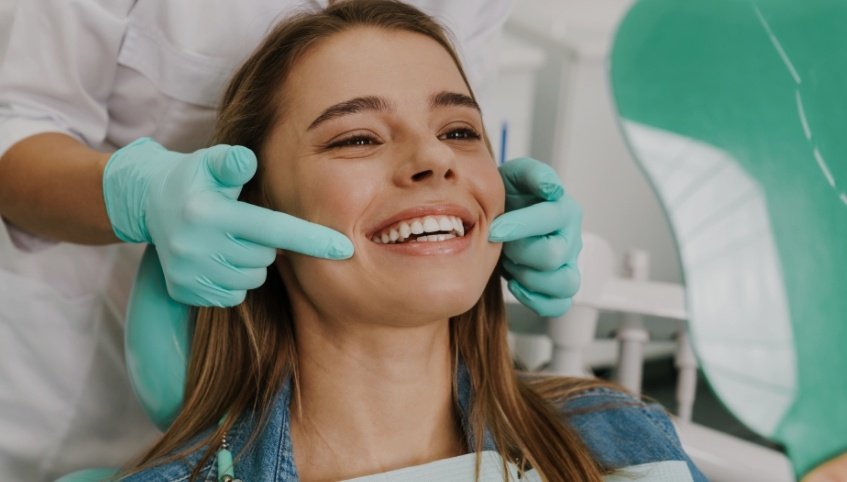 Young woman smiling while visiting her dentist in Yarmouth