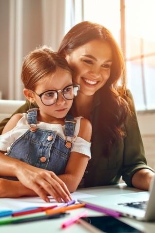 Mother and daughter looking at laptop together