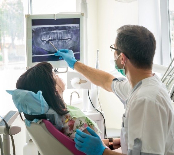 Dentist showing a patient x rays of their teeth