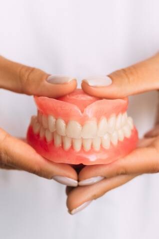 Dentist holding a set of full dentures