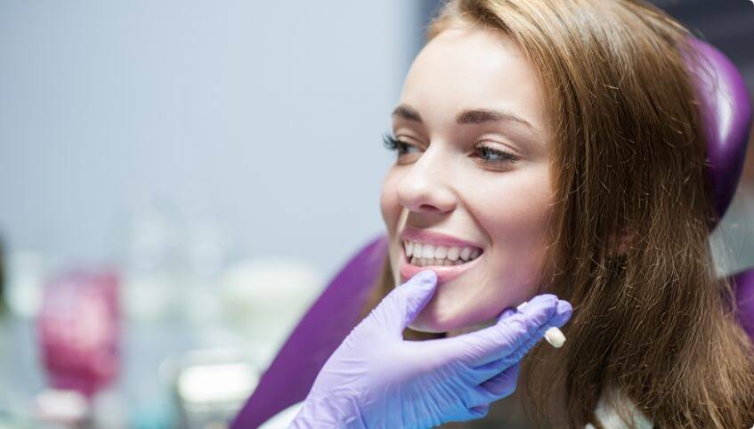 Woman smiling in dental chair after restorative dentistry in Yarmouth