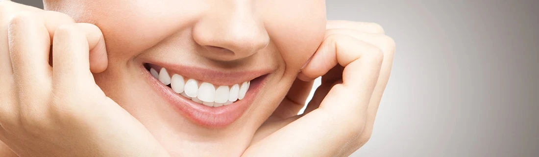 Dentist Yarmouth ME A Close Up of a Woman Smiling with Her Head Cradled in Her Hands Our Services Dentist Yarmouth ME A Close Up of a Woman Smiling with Her Head Cradled in Her Hands Our Services